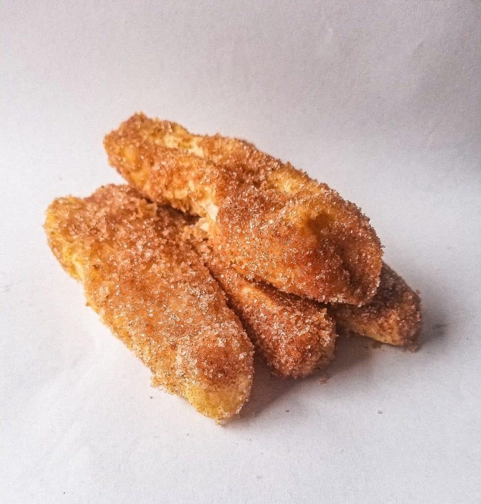 image of baked churros stack on top each other.