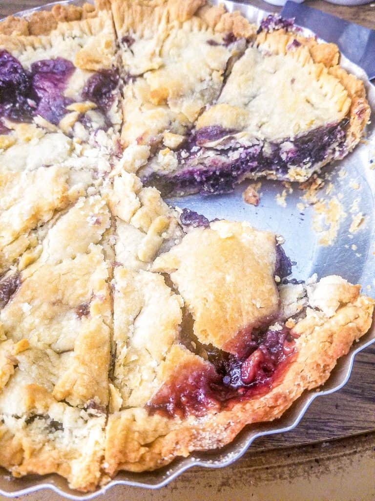 double crust mulberry pie in a pan.
