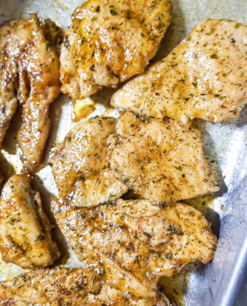 herb chicken on a silver baking tray. 