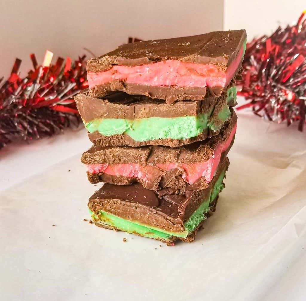 homemade andes mints stacked with garland in the background. 