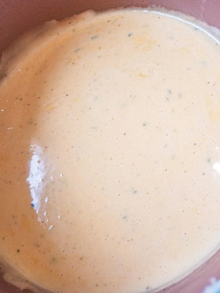 velveeta nacho cheese sauce in a brown pan.