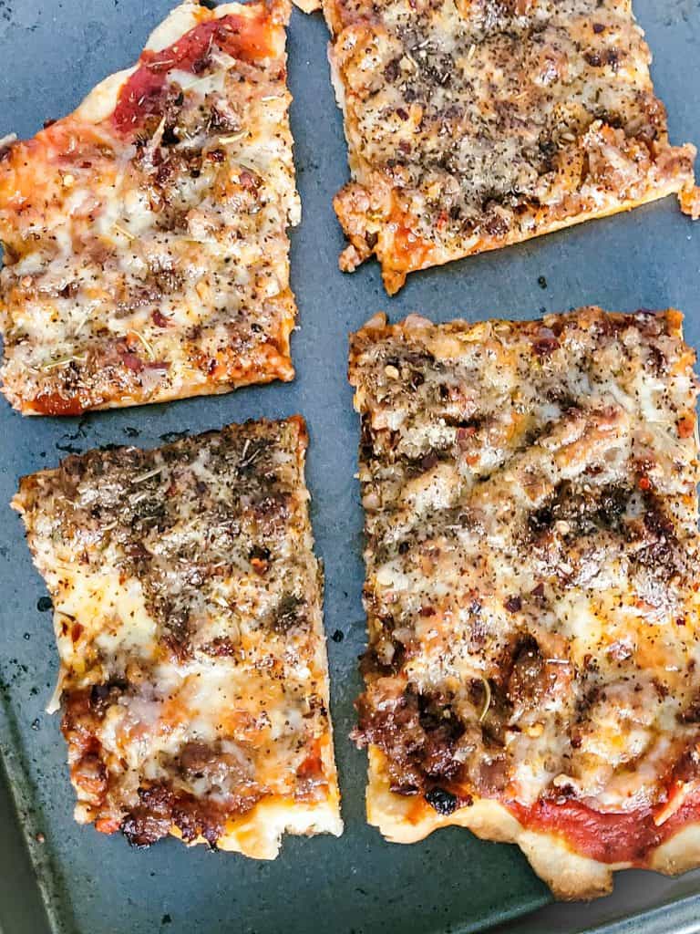 school lunch pizza on a gray baking sheet. 