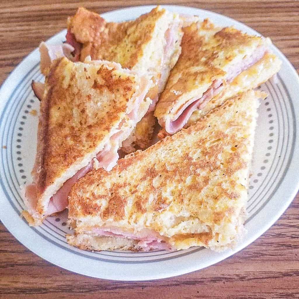 monte cristo sandwich stack on a plate on top of a table. 