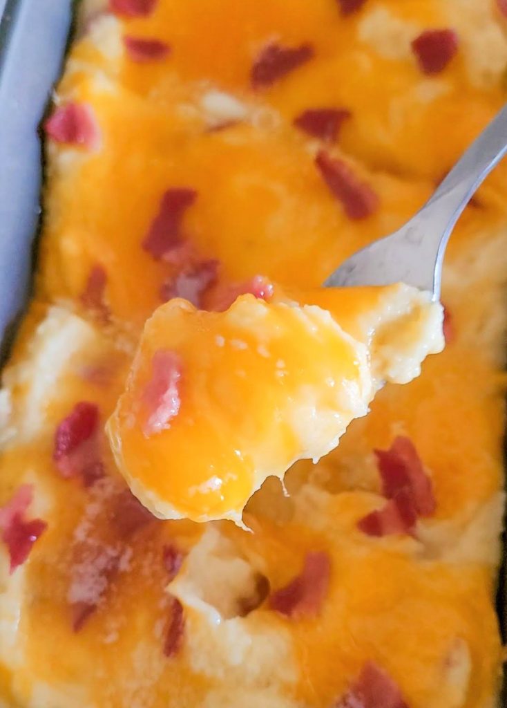 loaded mashed potatoes with a fork scopping out of the pan. 