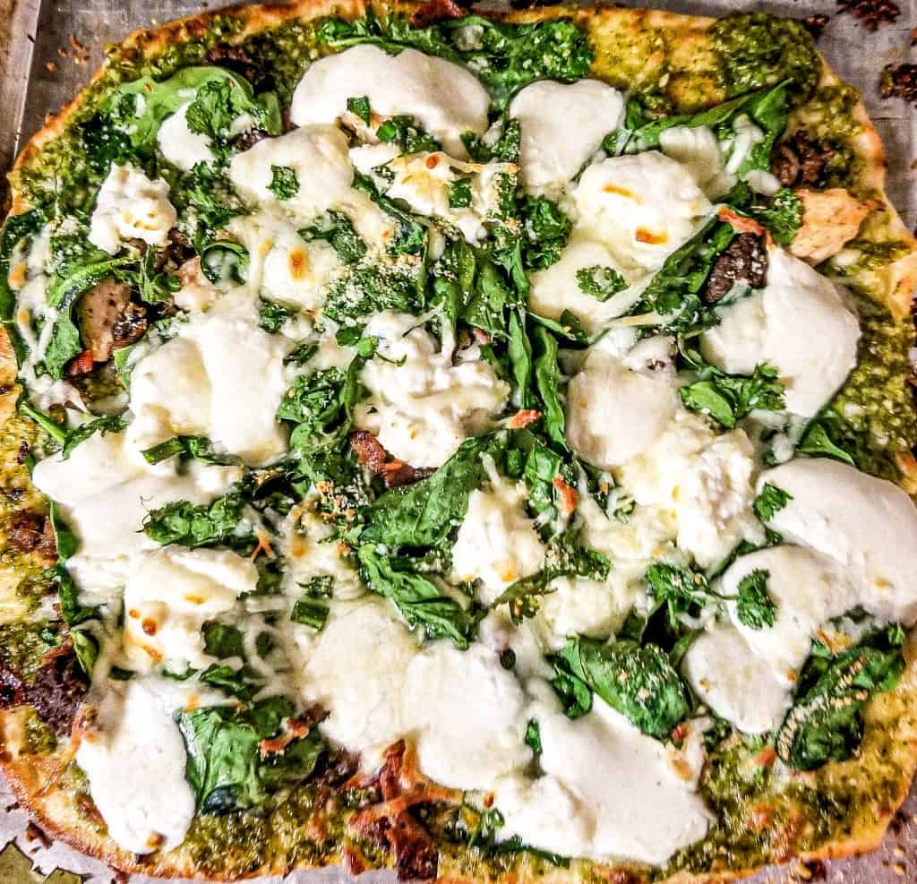 naan bread pizza on a baking sheet. 