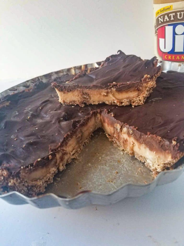 peanut butter cup cheesecake with slice taken out.