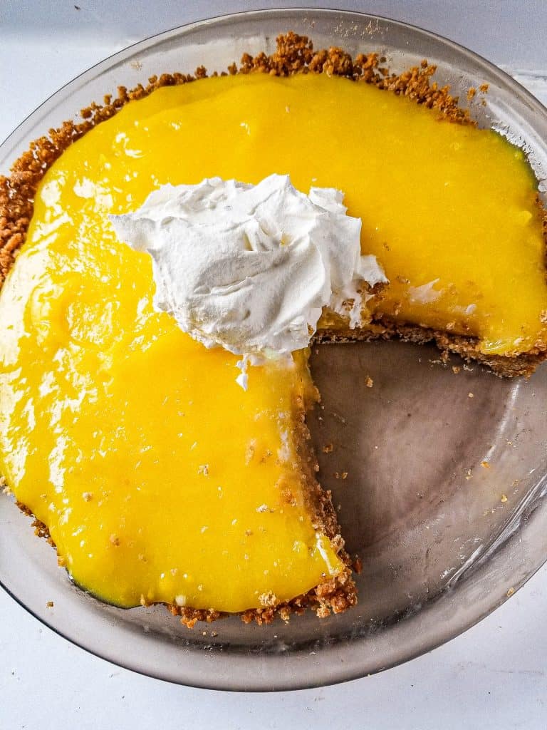 easy lemon pudding pie with whipped cream on top from top view. 