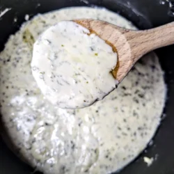 alfredo sauce with spoon on top.