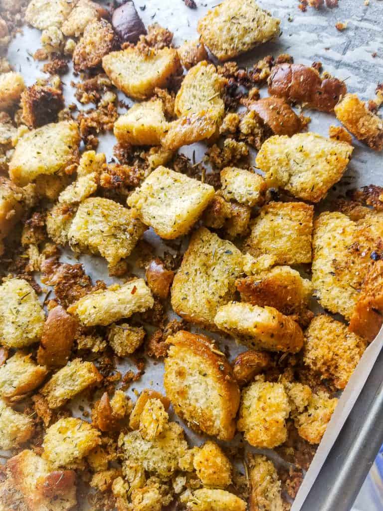 homemade croutons on a baking sheet with parchment paper.