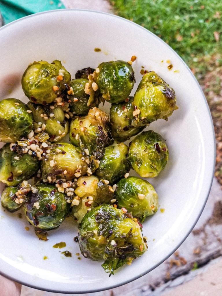 spicy brussel sprouts in a white bowl.