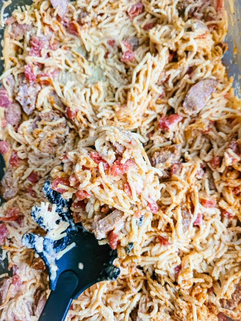 southern baked spaghetti with spoon coming toward camera.