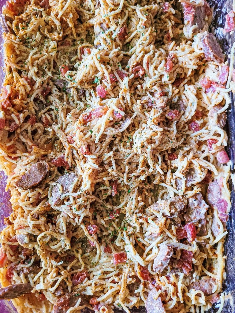 Cajun cream sauce with pasta in a glass baking dish. 