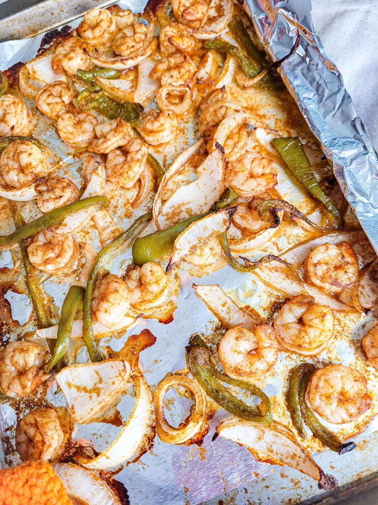 sheet pan shrimp fajitas on tin foil. 