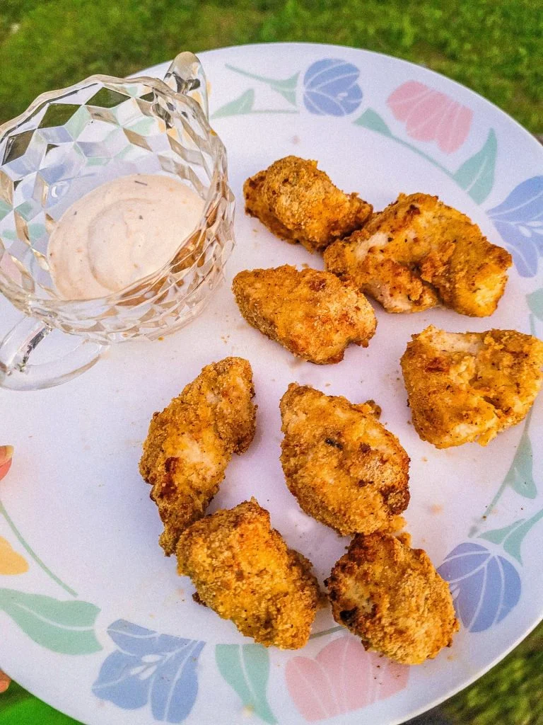homemade chicken nuggets on a plate  with ranch on the side. 