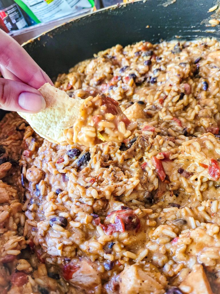 chicken burrito skillet dinner with chip getting scooped.