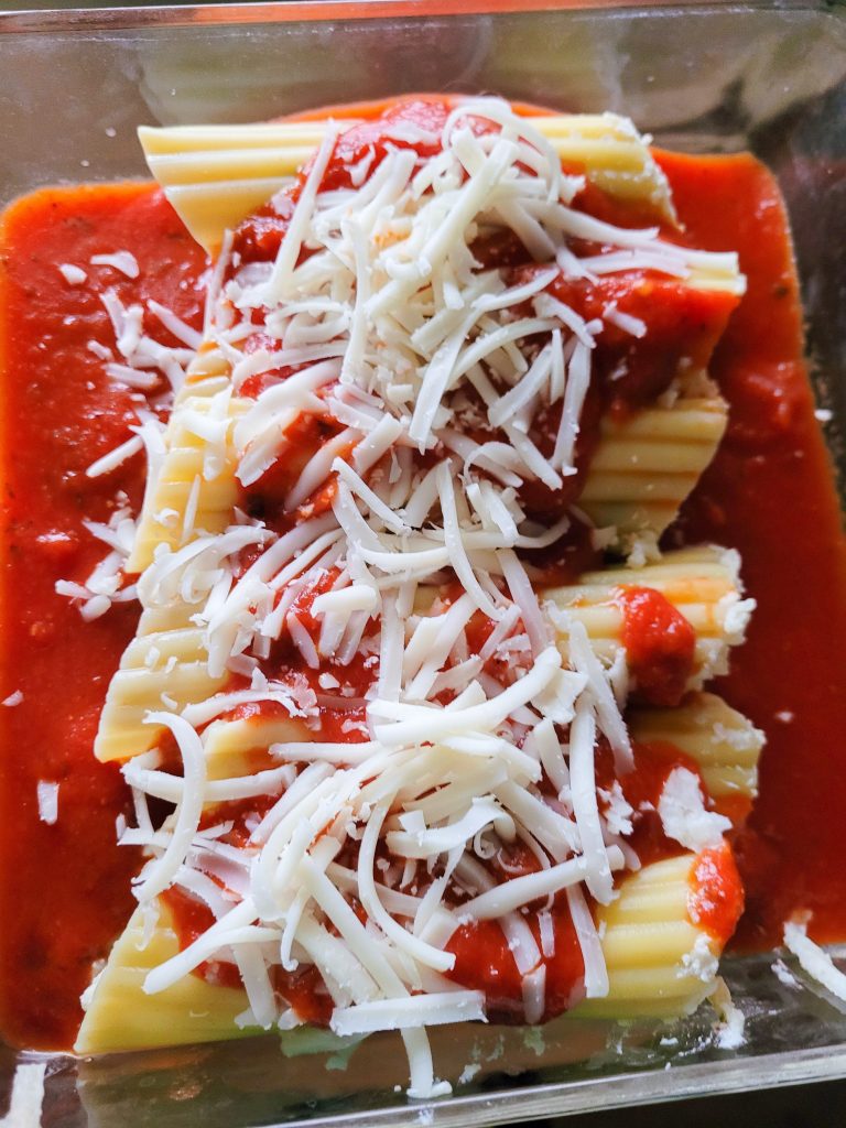 cheese manicotti top view in a glass pan.