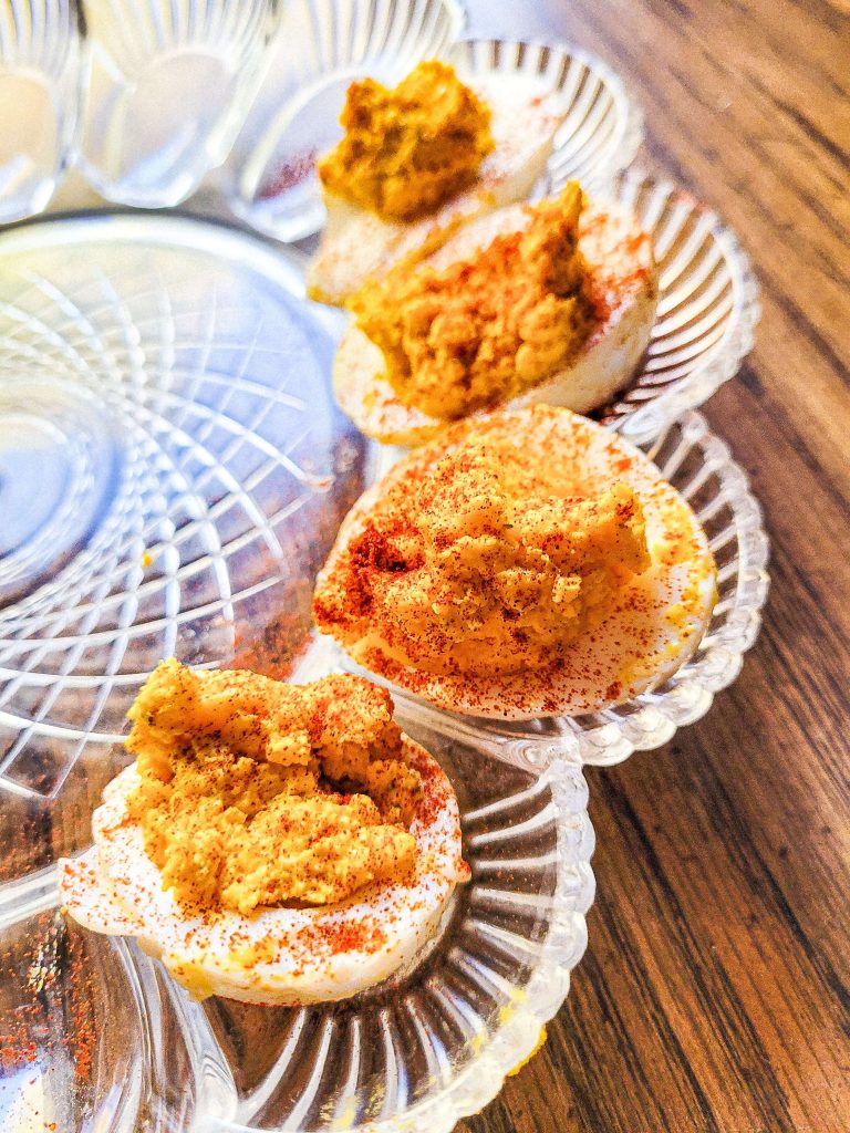 Sriracha deviled eggs recipe on a egg tray.