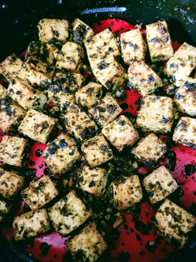 pesto tofu with red air fryer mat under.