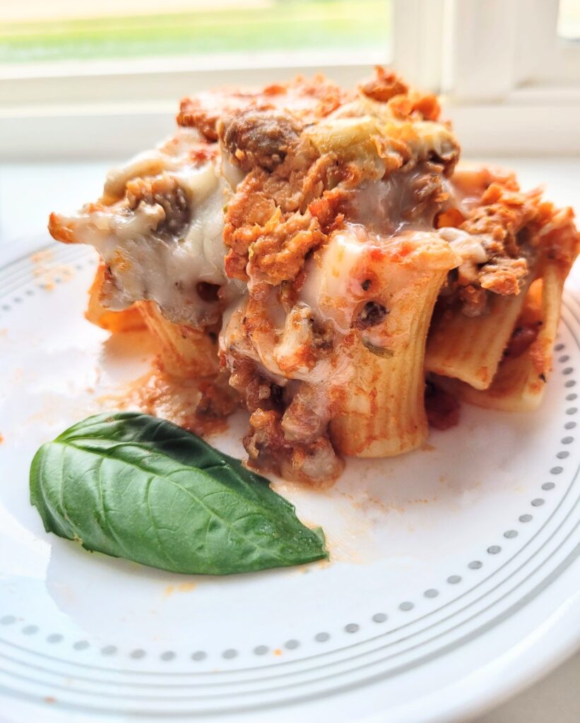 stuffed rigatoni with basil on a plate.