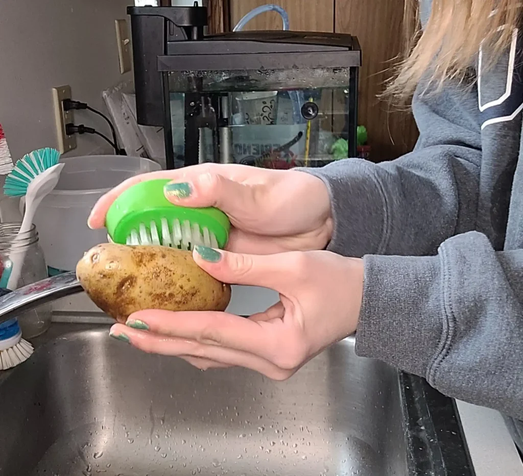 washing a potato.