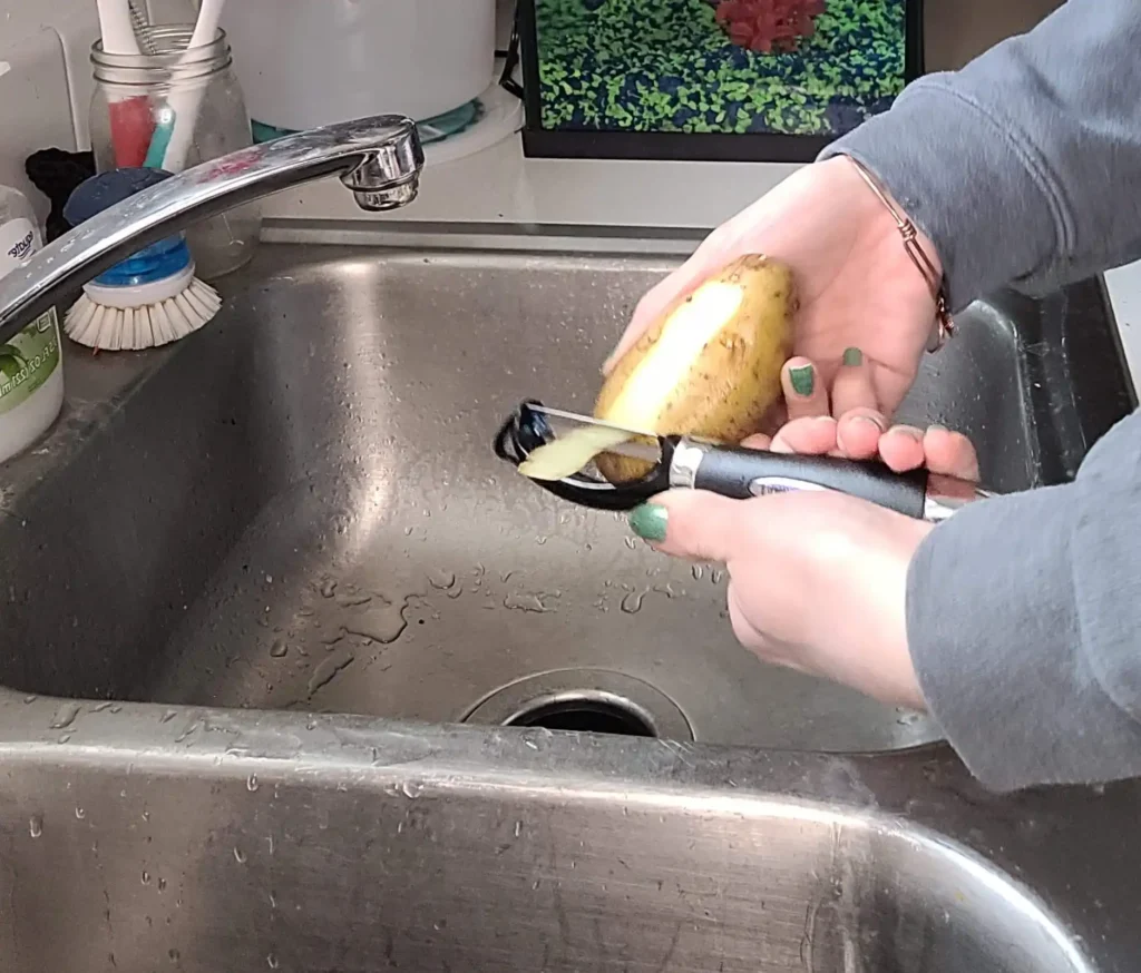 peeling the potato.