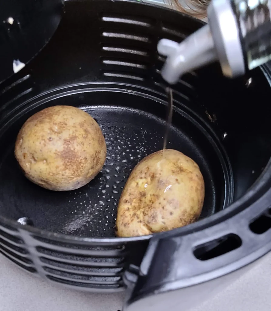 Potato being poured with olive oil.