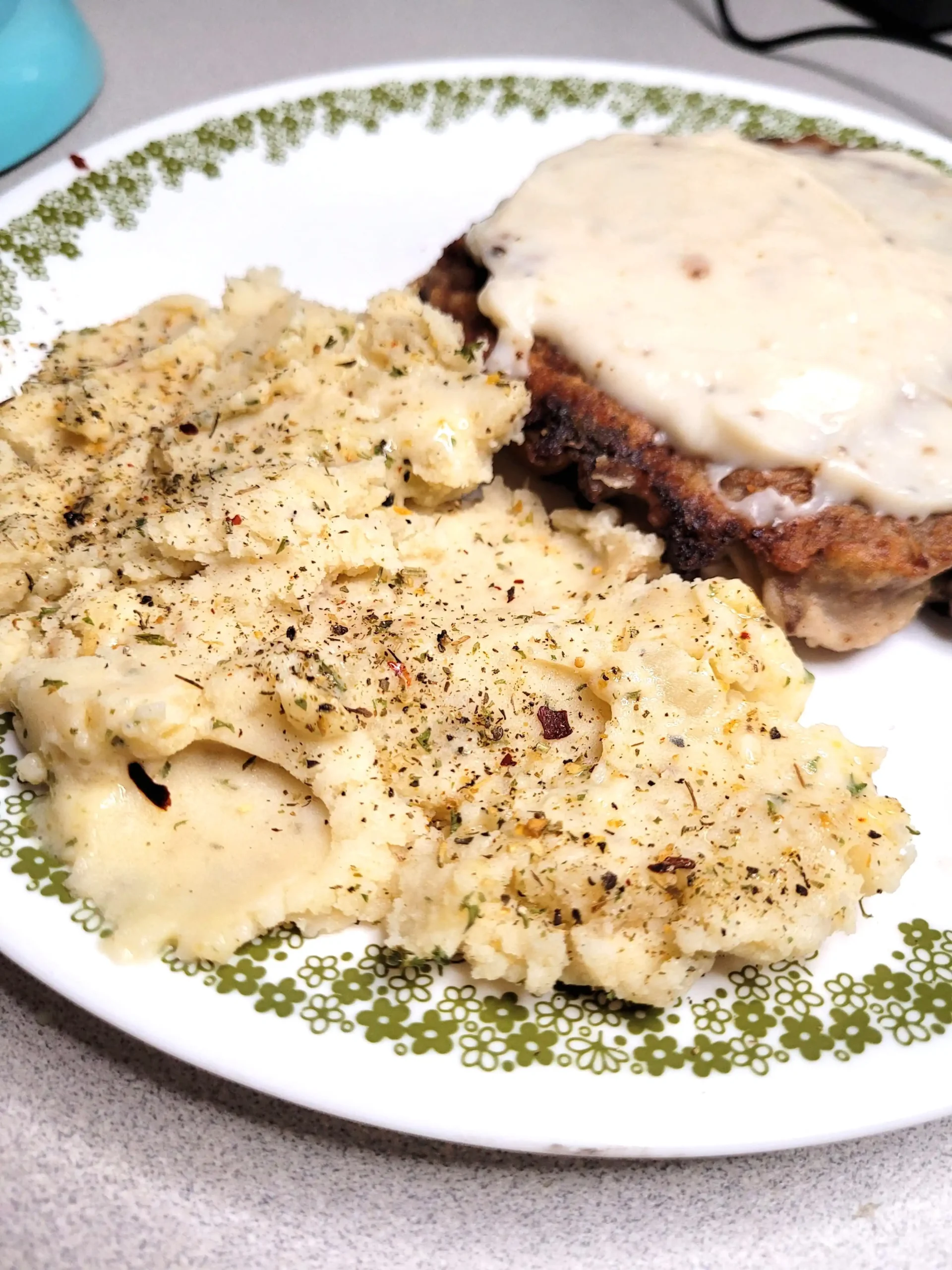 cream cheese mashed potatoes with chicken fried steak in the background.