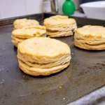 cooked biscuits on baking sheet close up.