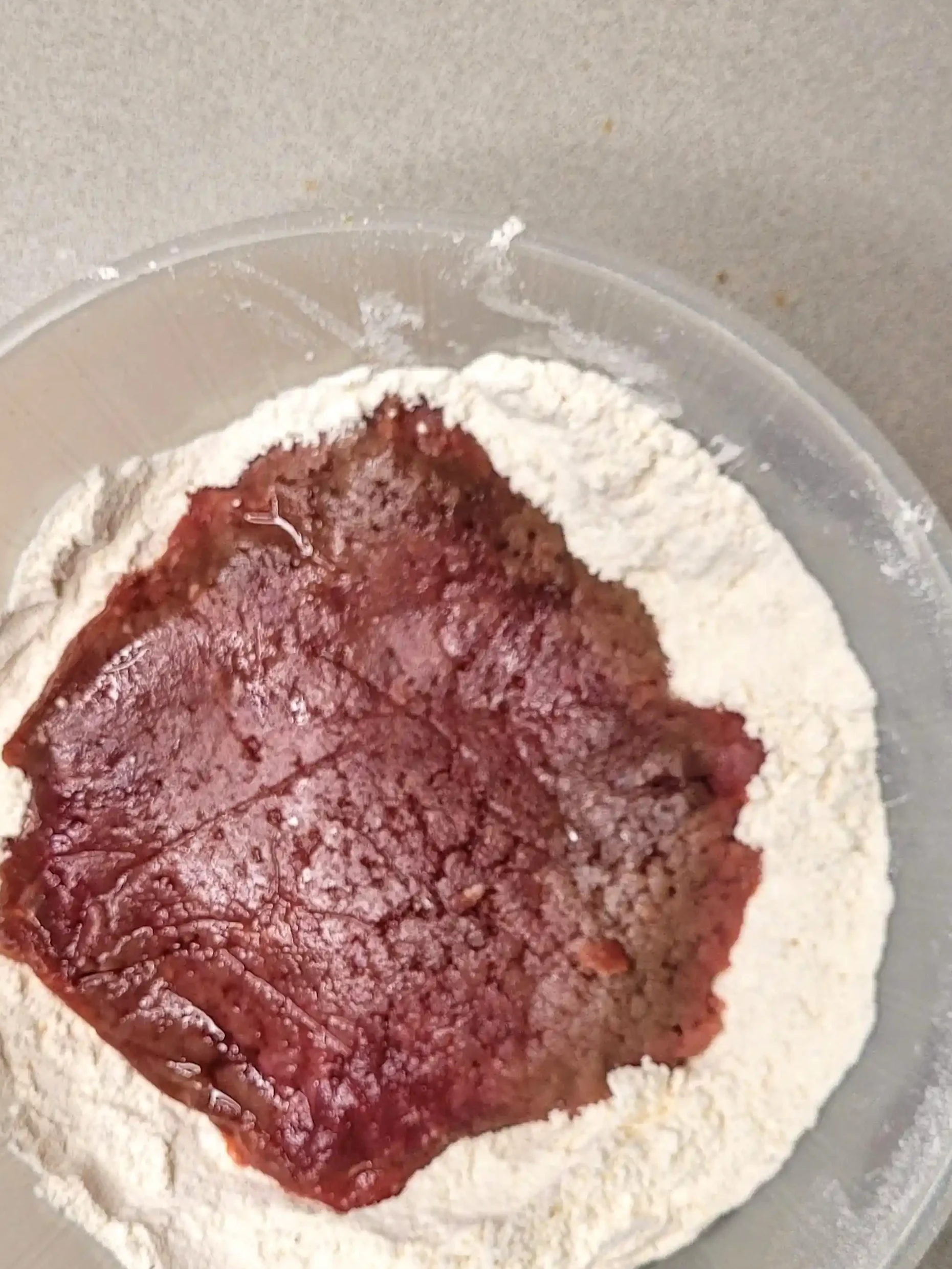 raw cube steak in flour bowl on counter.