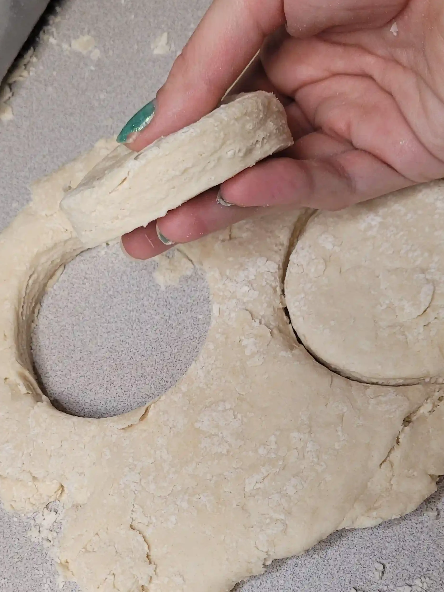 cut baking powder biscuit being held.