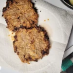 cooked cube steak on paper towels.