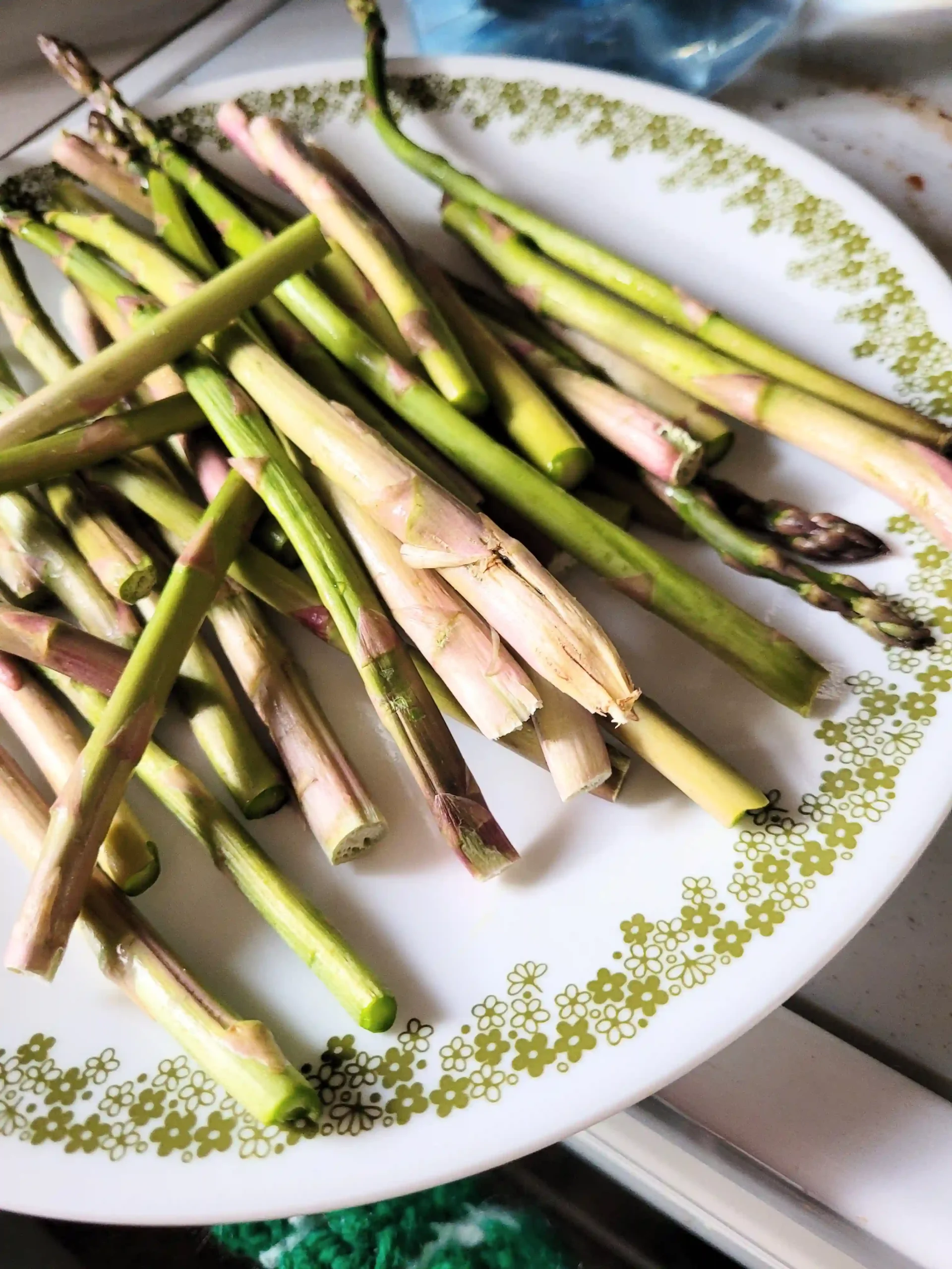 Asparagus end discard on a plate.