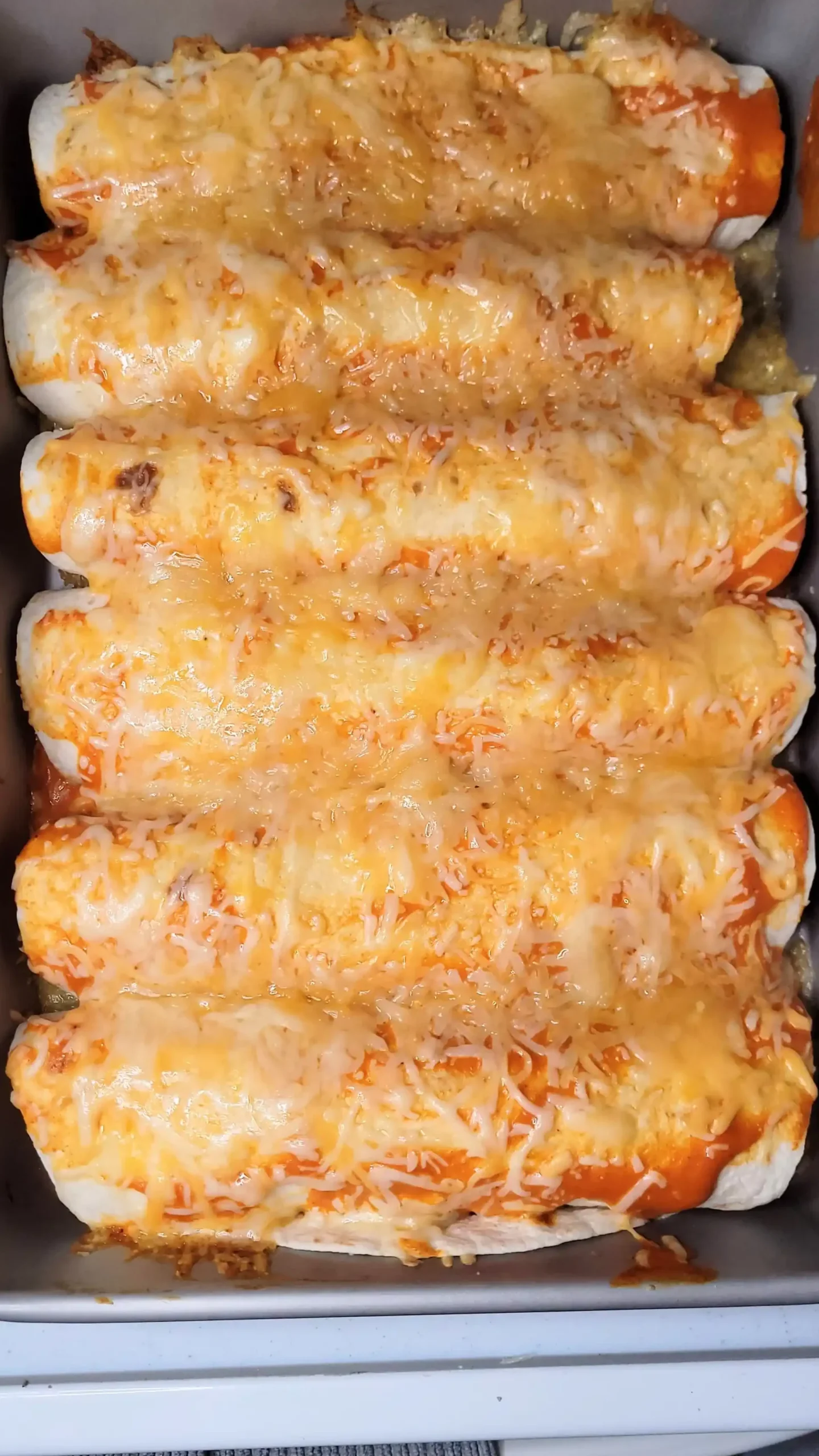 baked buffalo chicken enchiladas in pan.