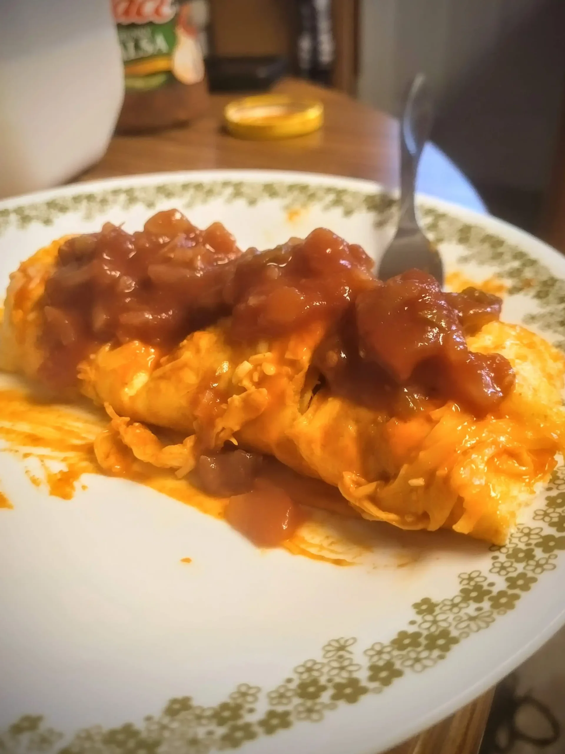 buffalo chicken enchiladas on plate with salsa on top.