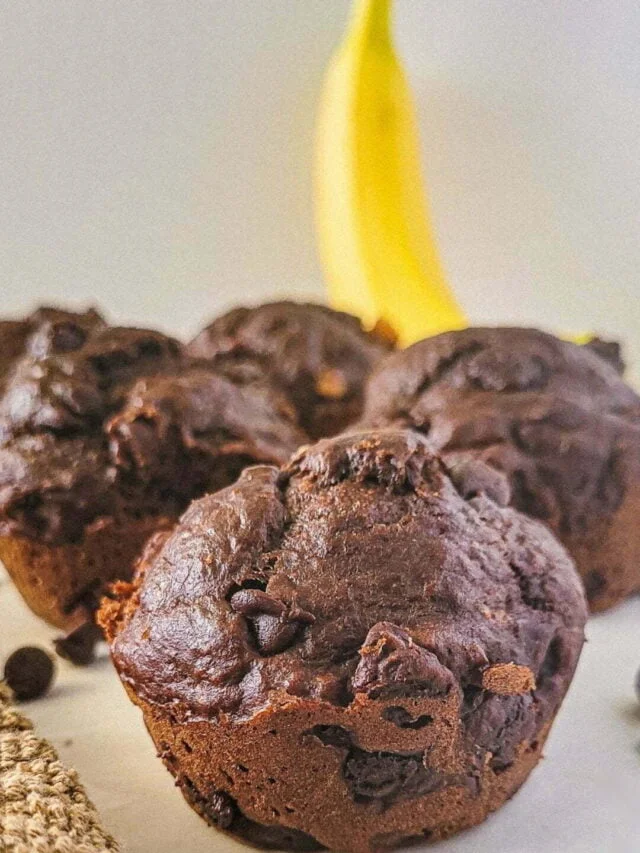 muffins close up with banana in back.