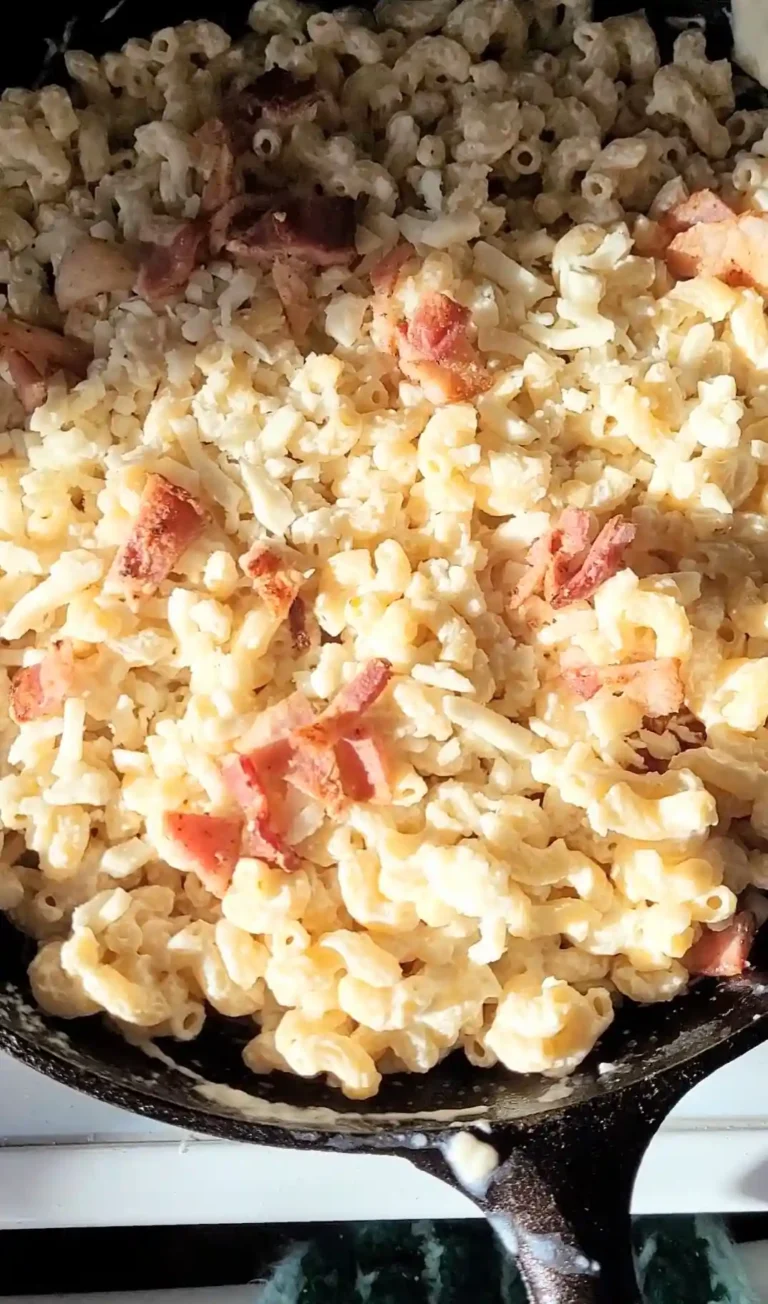 layered toppings of smoked mac and cheese in cast iron skillet.