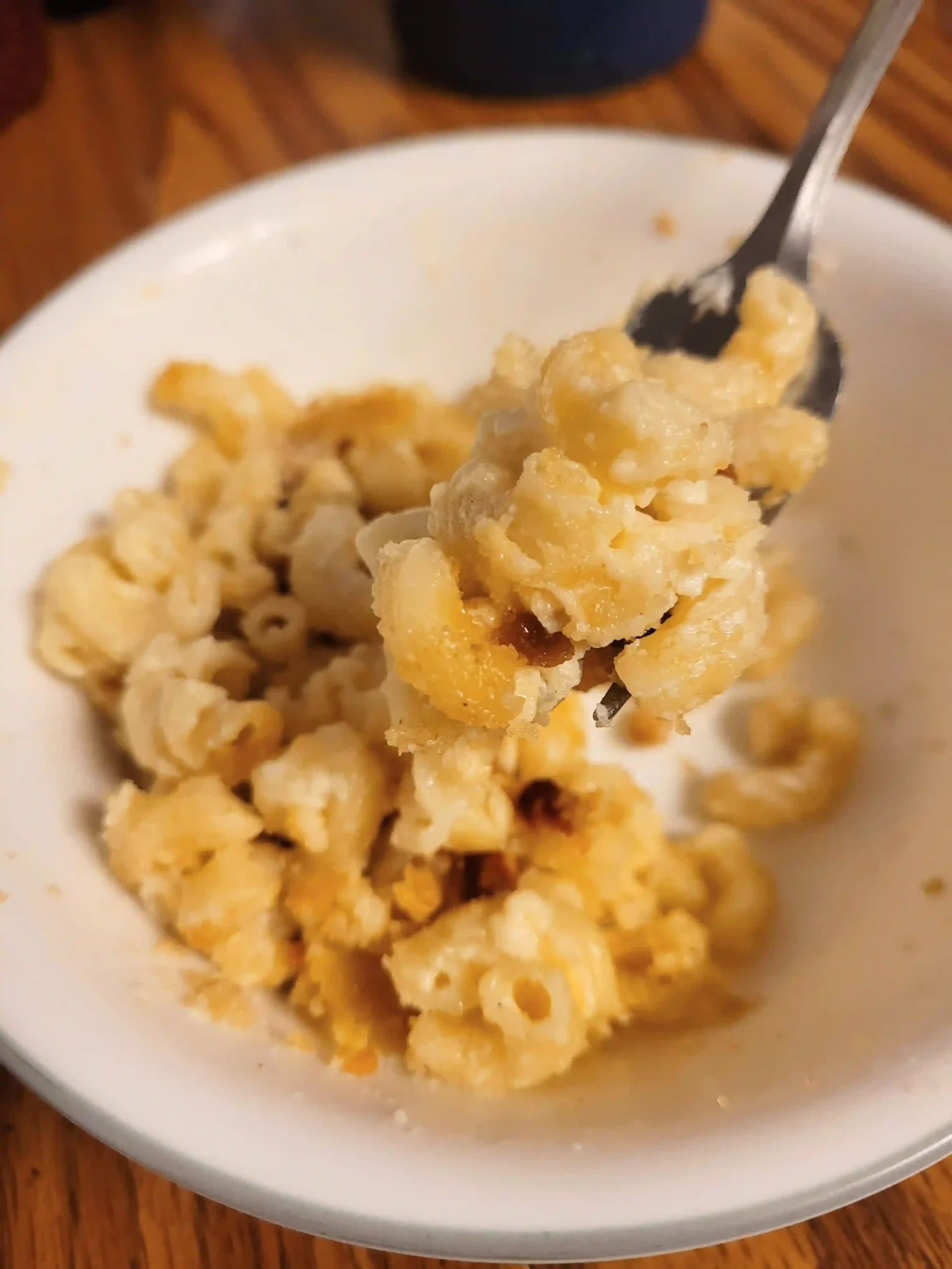 smoked mac and cheese with a fork and bowl.