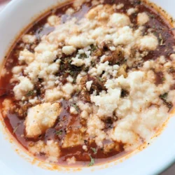 Close up of cheese on top of lasagna soup.