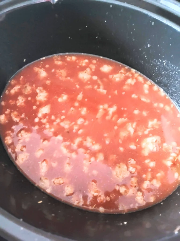 Sausage in marinara sauce in crock pot.