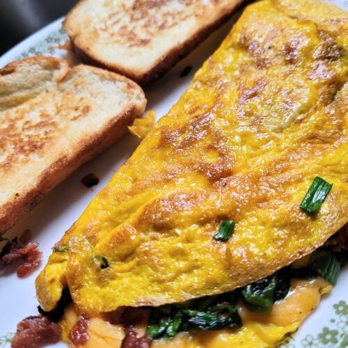 Spinach and cheese omelet with toast in the background.