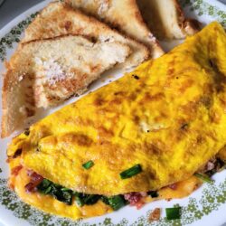 cheese omelet with spinach with toast cut into triangles.