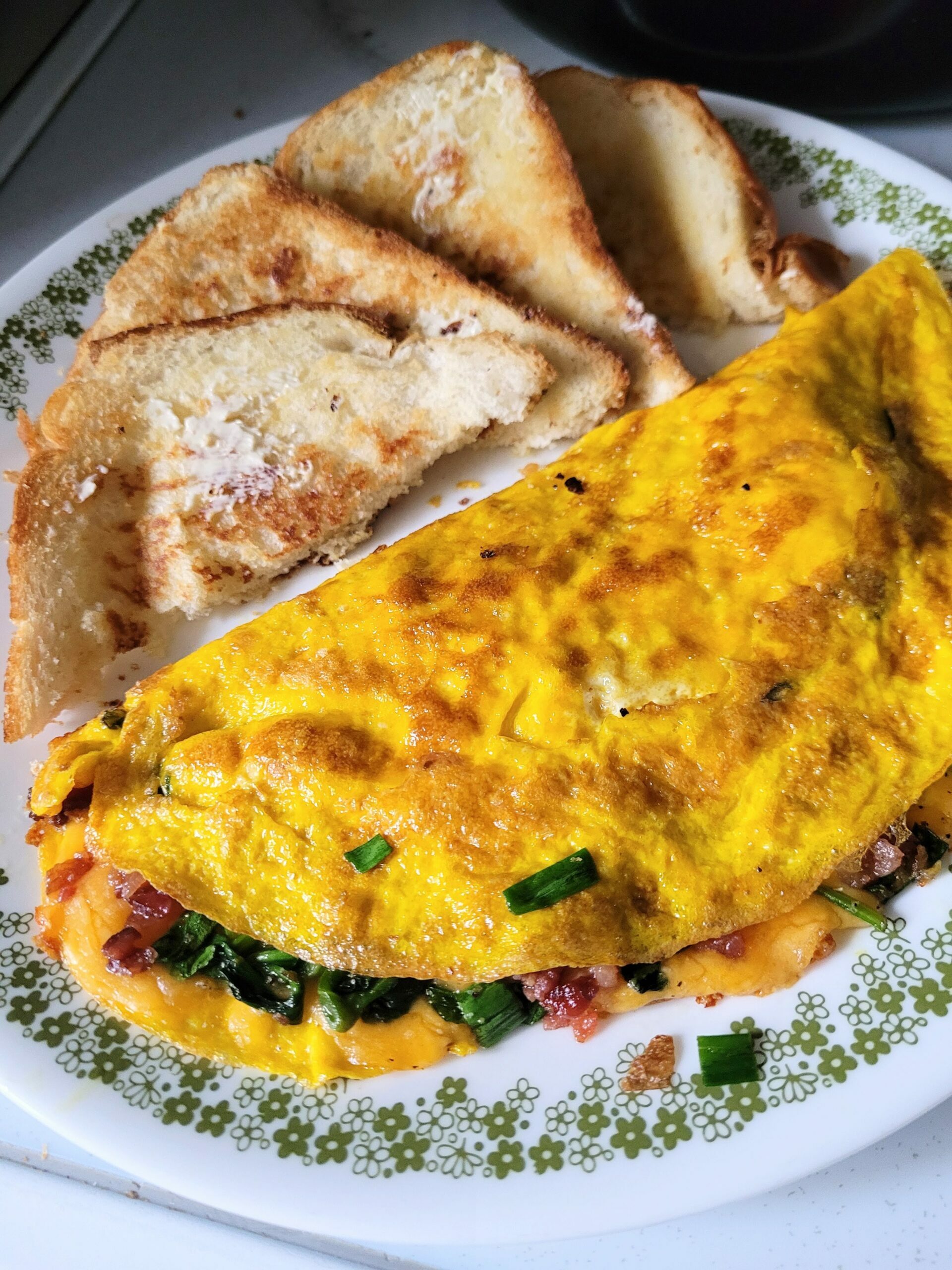 cheese omelet with spinach with toast cut into triangles.