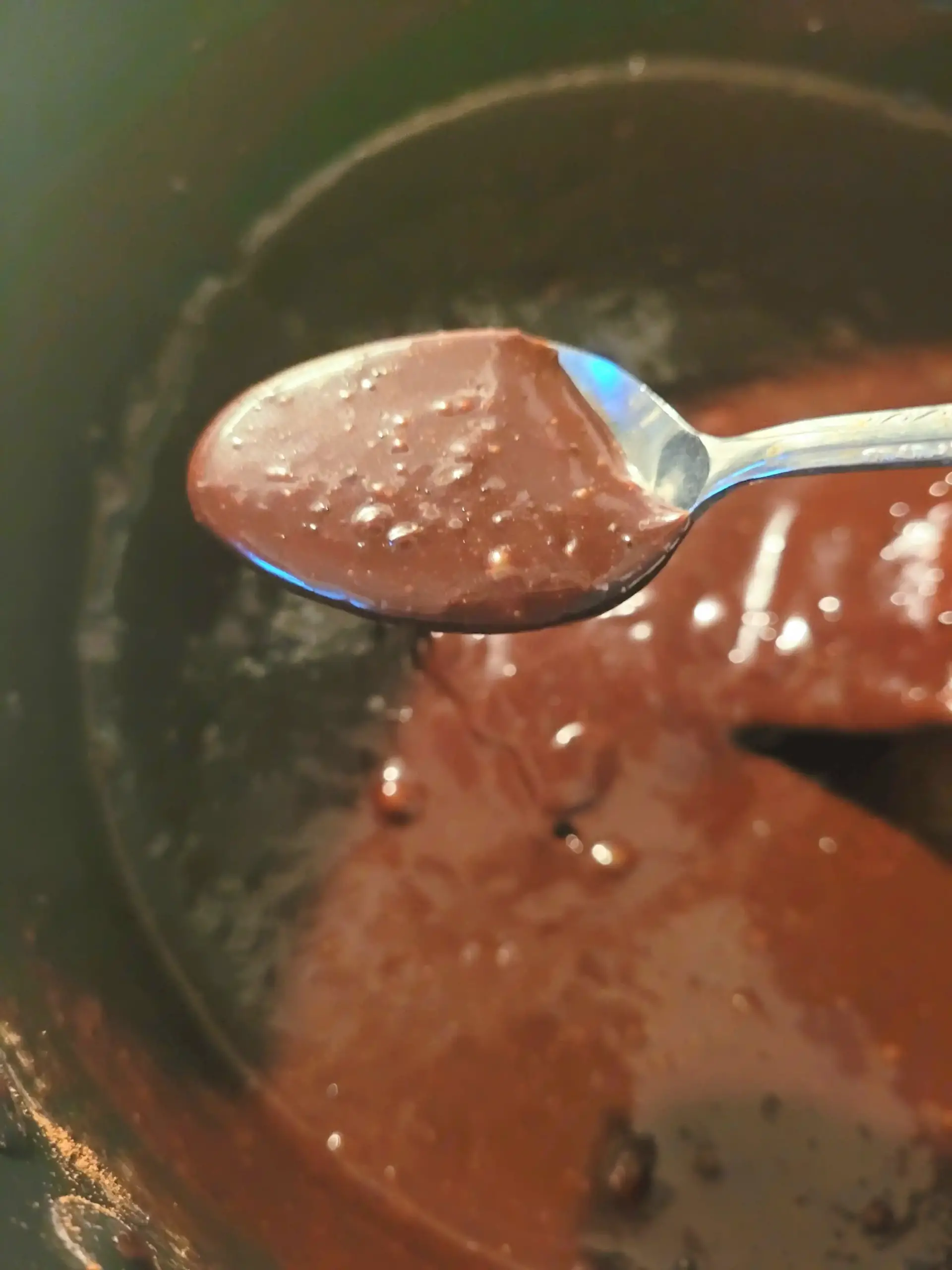 Hot fudge sauce on spoon.